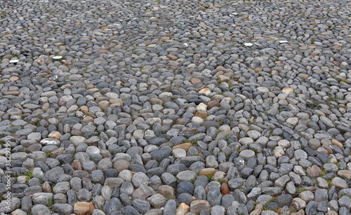 Pavement of the Piazza Grande, main square in the city center of Locarno, a city in Italian speaking canton in Switzerland. The round stones are cemented together. 