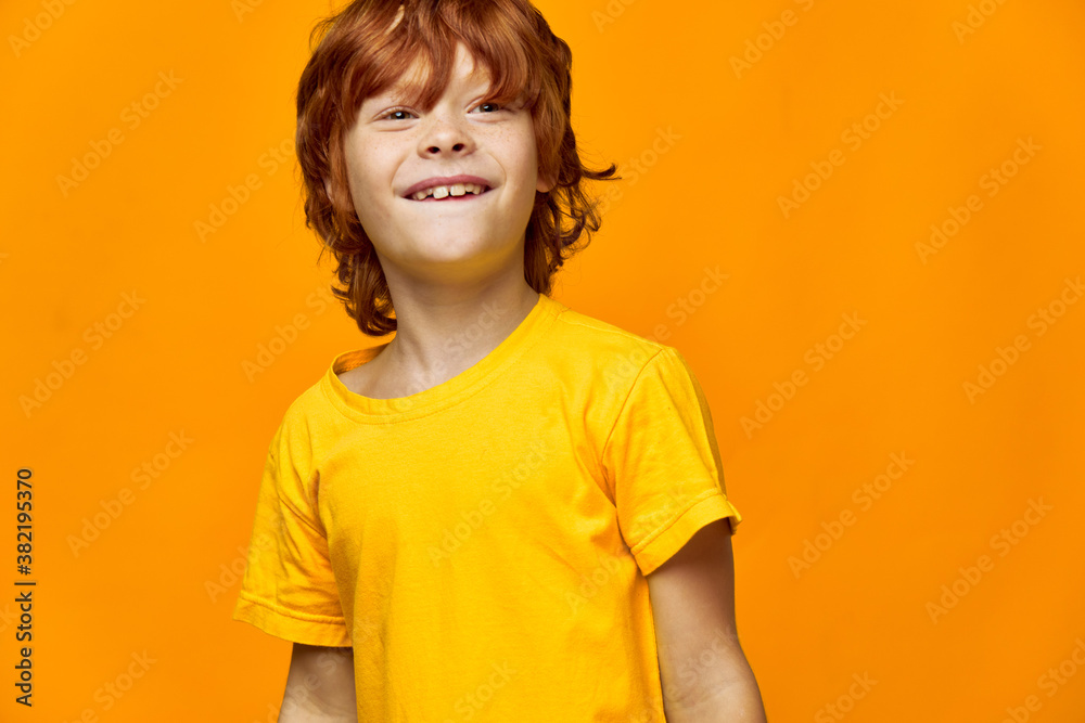 redhead boy laughing and looking to the side on isolated background redhead boy laughing and looking to the side on isolated background