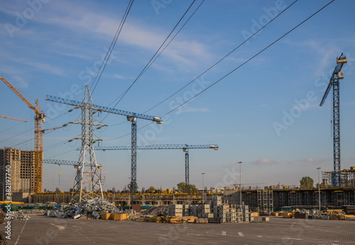 Kiev, Ukraine - SEPTEMBER 13th 2020 Construction site of shopping mall with many cranes on a background of blue sky with cirrus clouds. Kyiv. Obolon