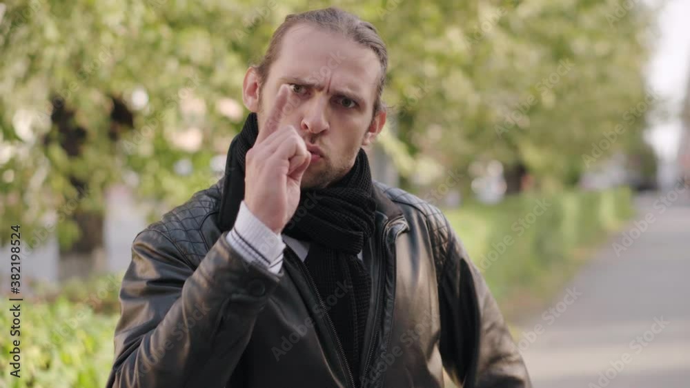 Portrait man shaking index finger toward the camera several times means prohibition. Finger wag. Portrait man shaking index finger toward the camera several times means prohibition. Finger wag.