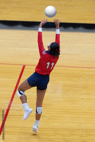 Young girl playing in a competitive volleyball match