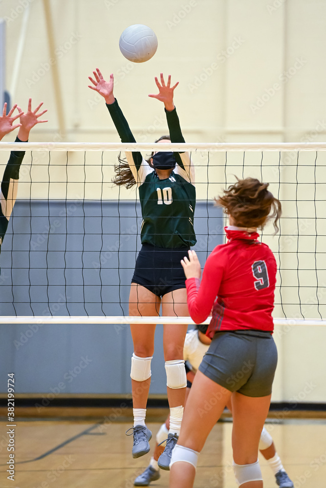 Young girl playing in a competitive volleyball match