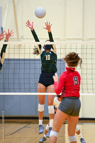 Young girl playing in a competitive volleyball match