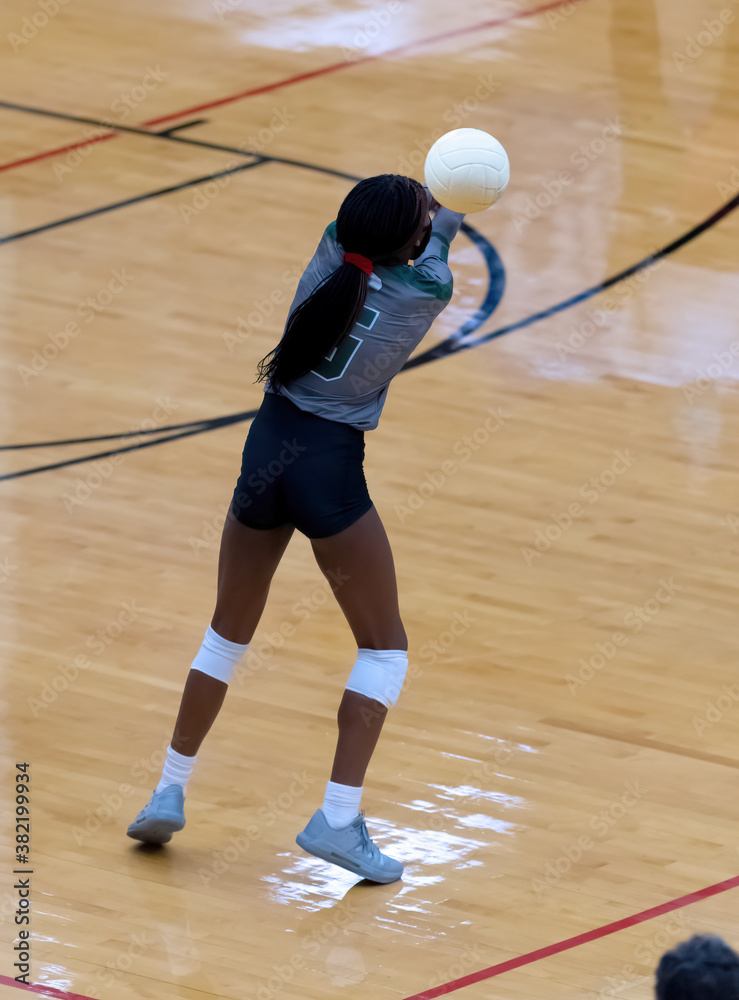 Young girl playing in a competitive volleyball match