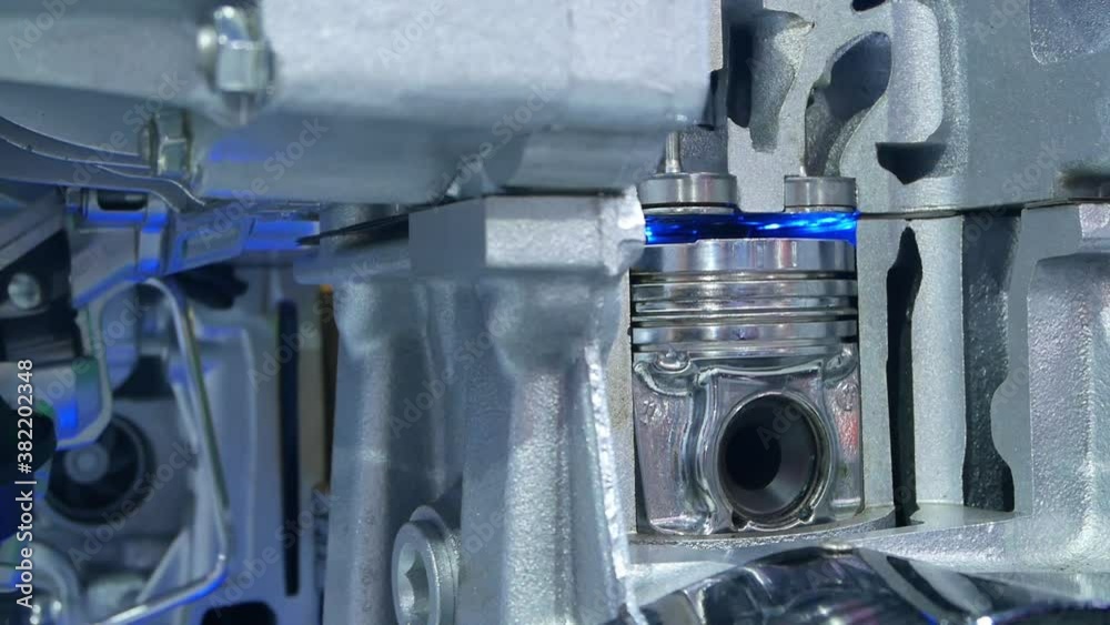 Inside view of engine, close up detail of two pistons in cylinder,some gears aside.