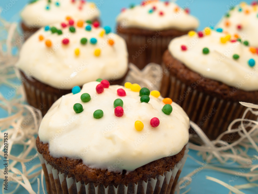 Carrot muffins with cream cheese frosting and sprinkles Carrot muffins with cream cheese frosting and sprinkles
