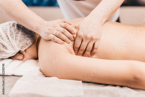 Professional face, back and legs massage in the massage parlor - spa treatments for young skin