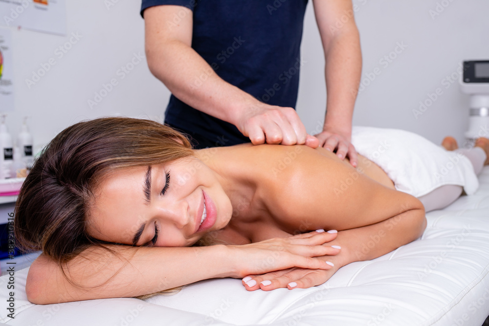 Relaxed woman receiving a massage.