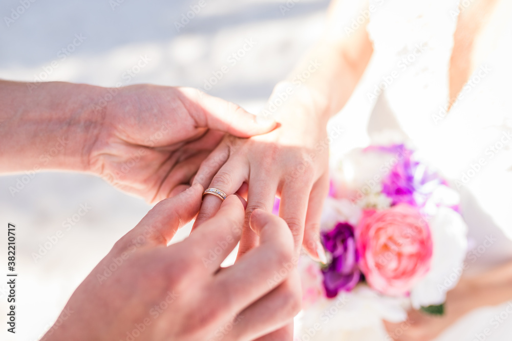 Close up view of ring exchange at the wedding ceremony on the paradise beach, Punta Cana, Dominican Republic 