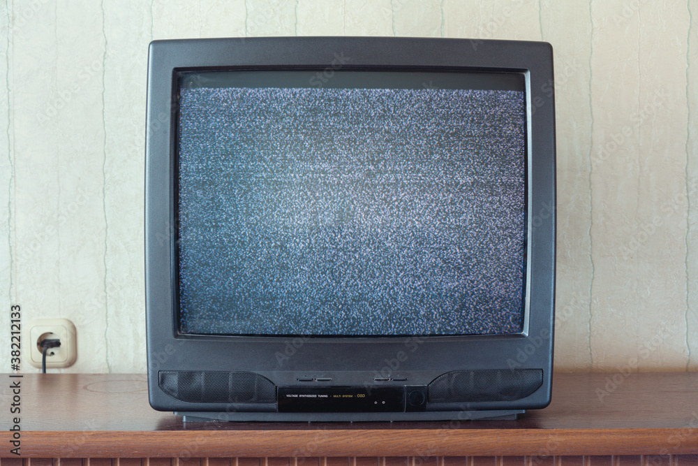 glith television analog signal on tv screen on wooden stand closeup