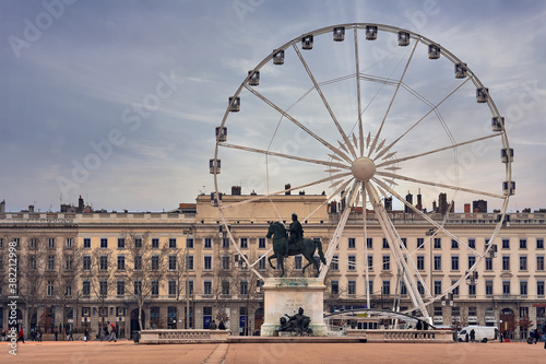 Bellecour square with Louis XIV statue and a big wheel