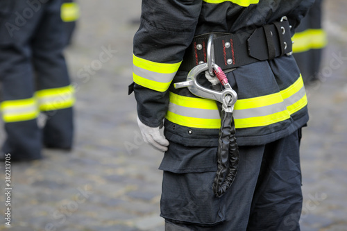 Details with the carabiner and harness of a firefighter.