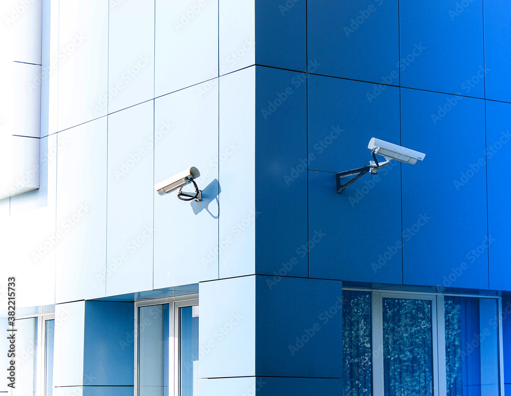 Two surveillance cameras on the building are deployed in opposite directions. Two surveillance cameras on the building are deployed in opposite directions.