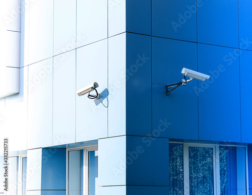 Two surveillance cameras on the building are deployed in opposite directions.