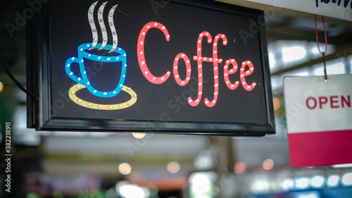coffee neon sign, on cafe or restaurant hang on door at entrance. Vintage color tone style.