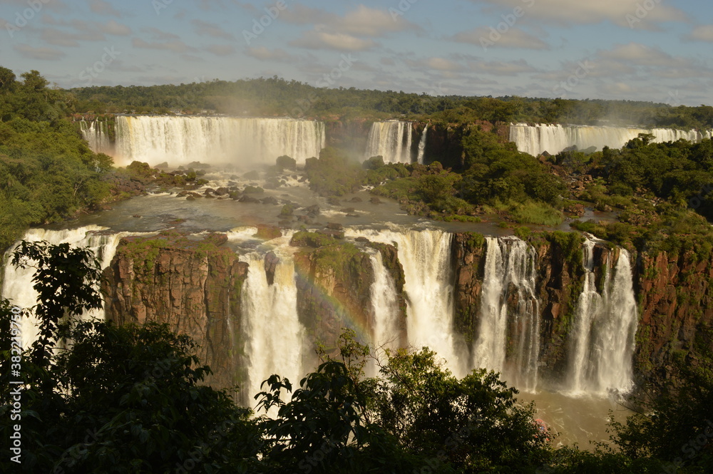 A rainbow over the huge Iguazu River and Waterfalls in Brazil and Argentina