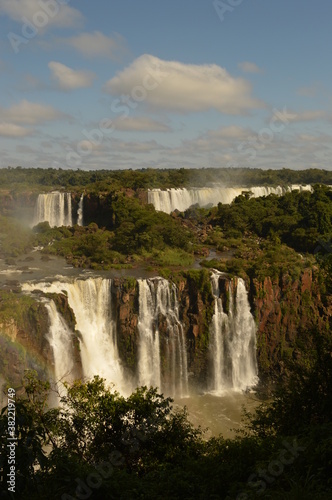 A rainbow over the huge Iguazu River and Waterfalls in Brazil and Argentina