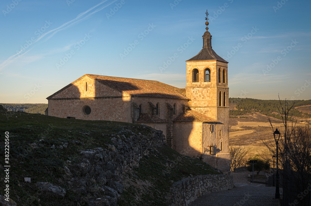 Street of the village of Cogolludo with the church in the background at sunset, Guadalajara, Spain Street of the village of Cogolludo with the church in the background at sunset, Guadalajara, Spain