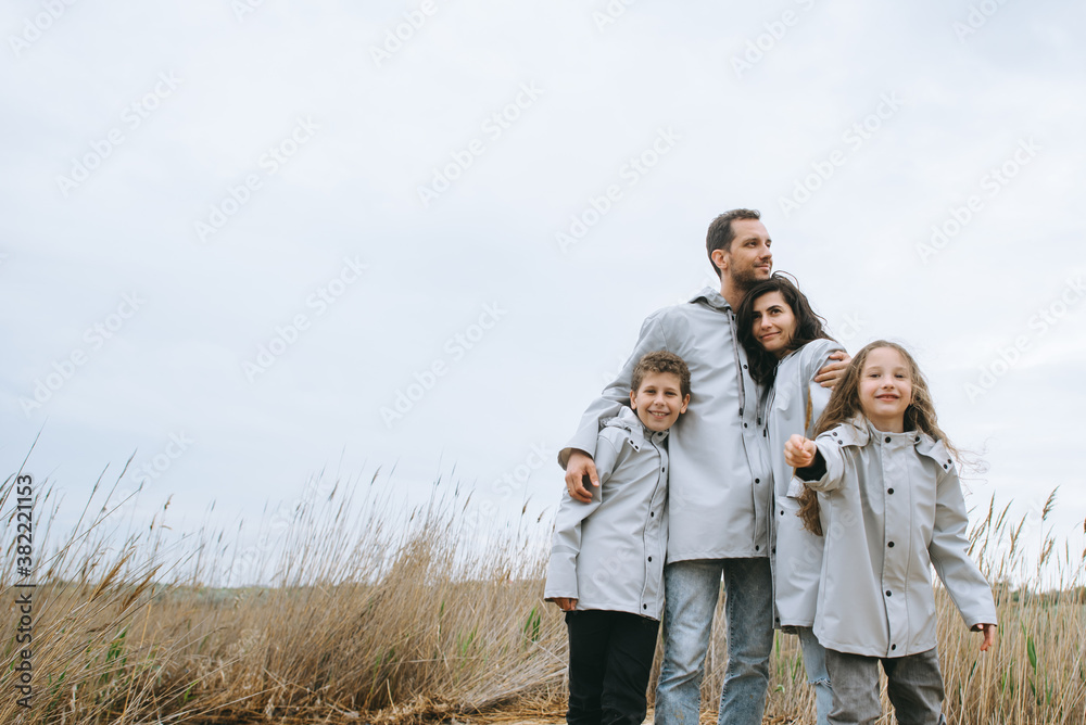 Beautiful family portrait dressed in raincoat Beautiful family portrait dressed in raincoat