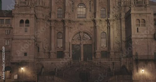 Santiago de Compostela cathedral facade at dusk. Camera tilt from towers to square