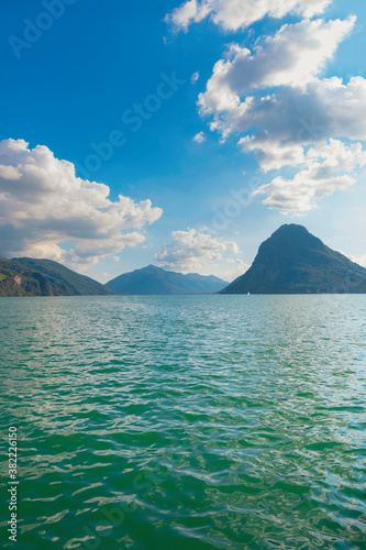 Beautiful landscape, wavy water of the lake and mountains on the horizon © Allusioni