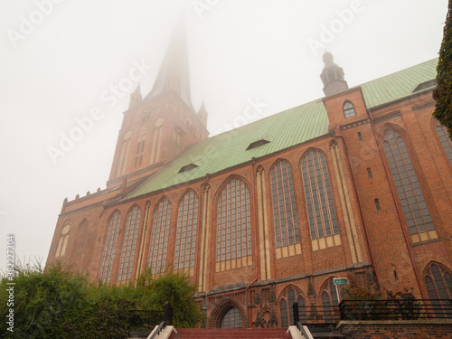 View of the Basilica of St James the Apostle in Szczecin during an autumn foggy day