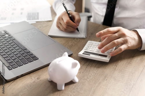 white piggy bank on wooden table. money savings, cash deposit concept