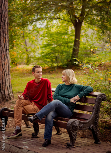 Beautiful woman,blonde,middle-aged,walking with her big son , autumn in the Park,Sunny day.