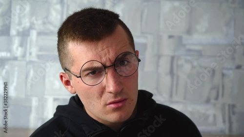 disgruntled man looks at the camera