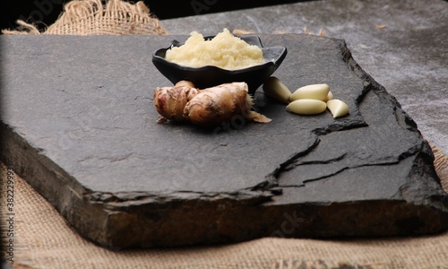 Ginger Garlic paste / Fresh mashed Adrak and Lahsun in bowl and whole.