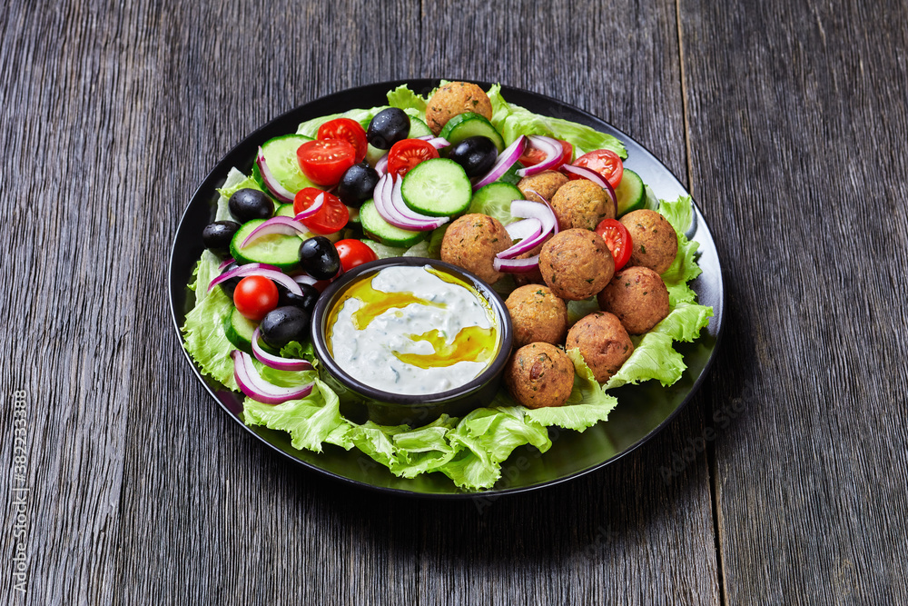Platter of falafels with vegetables with tzatziki Platter of falafels with vegetables with tzatziki