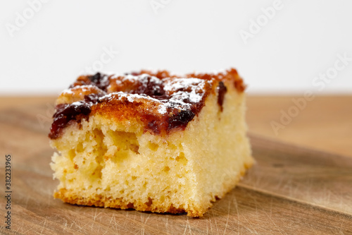 A small portion of cherry pie on a plank