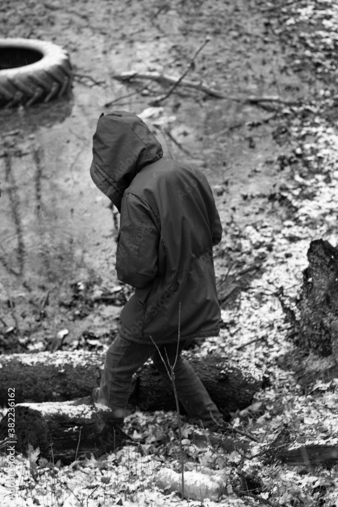Black-white photo of a man on a background of forest, water. Black-white photo of a man on a background of forest, water.