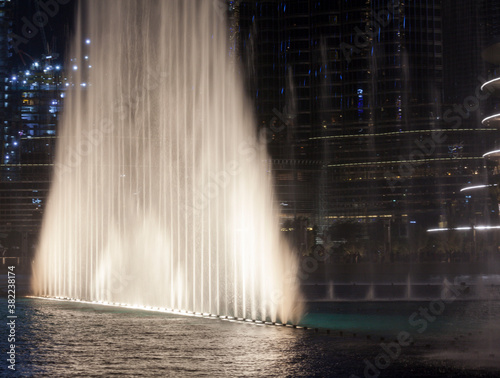 Famous musical fountain in Dubai shopping mall. Dance of the water and water is in the air with great illumination. Lightened water show near Burj Khalife.