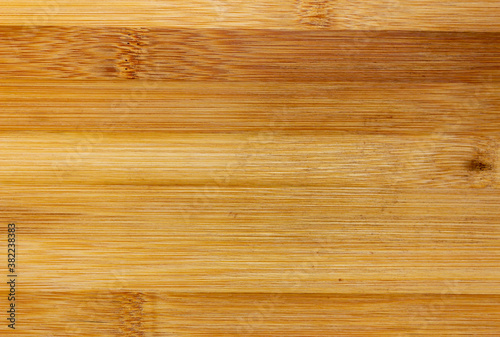 Texture Of Wooden Board Made Of Bamboo. Background Photo Of Texture Of Wooden Chopping Board Made Of Bamboo. Kitchen cutting Board made of bamboo. Board made of natural bamboo wood.
