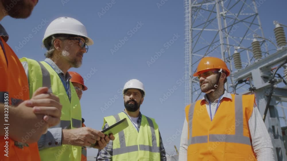 Builders discussing power plant construction Builders discussing power plant construction