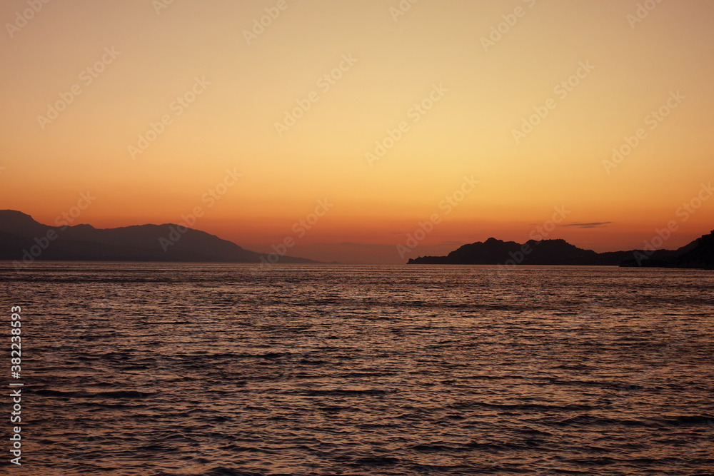 Beautiful sunset over Aegean sea as seen from Santorini island, Cyclades, Greece
