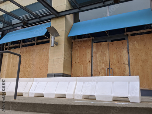 boarded up windows and doors in a downtown building during protests and riots