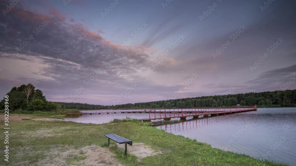 custom made wallpaper toronto digitalTime lapse of a smooth lake during sunset mirroring the forest surrounding it. Beautiful sky changes during sunset showing all the colours.
