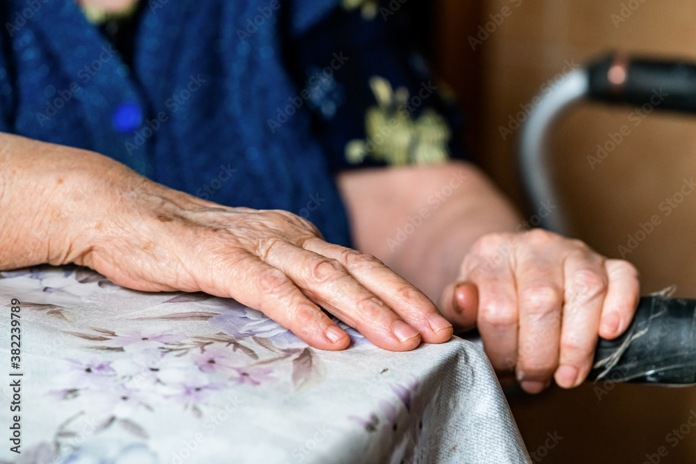 Hands of an elderly woman rests on on a walker. medical and healthcare concept.