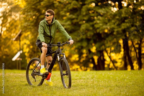 Young man riding ebike in the park