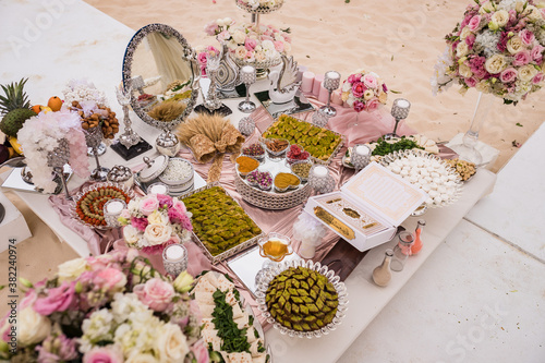 Photographie Close up view of Persian (Iranian) wedding table set with Holy Book of Quran, mi