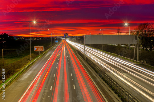 Red sky sunset, traffic light trails, M8 Motorway, Scotland, United Kingdom