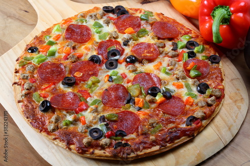 Delicious pizza with salami and vegetables