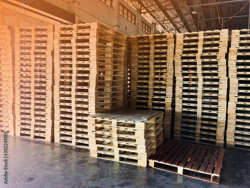 Worker driving forklift to loading wooden pallets from truck to warehouse cargo storage, shipment in logistics and transportation industrial, wood pallets stack, delivery service