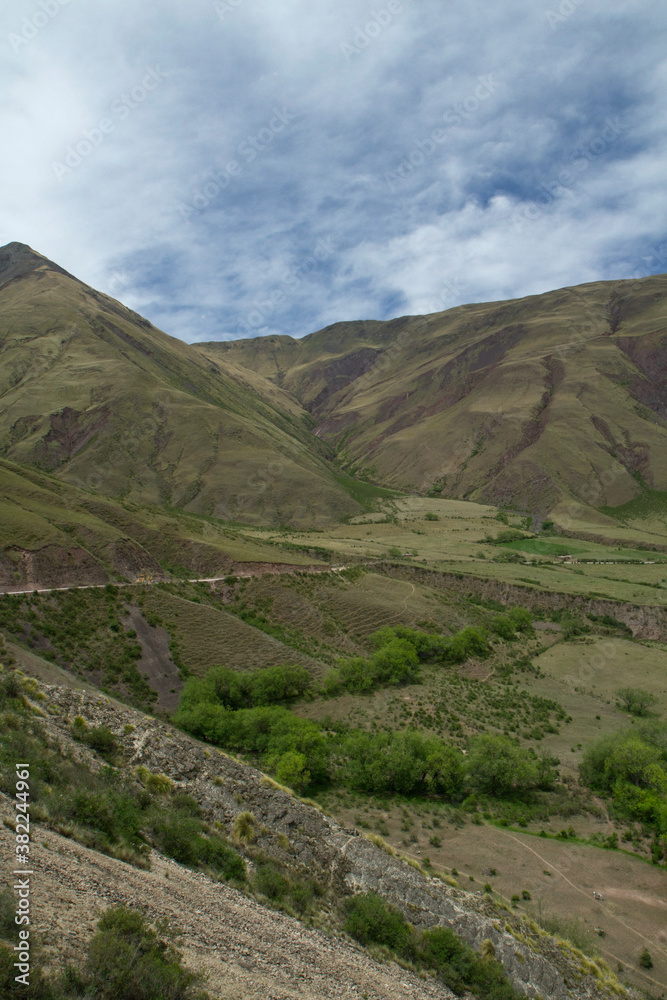 The road high in the mountains. View of the rural highway across the green hills and valley. 