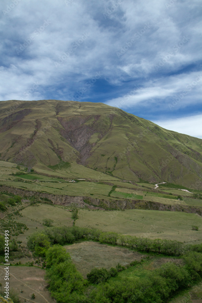 The green valley and hills under a blue sky. View of the popular landmark Bishop's slope in Salta, Argentina. 