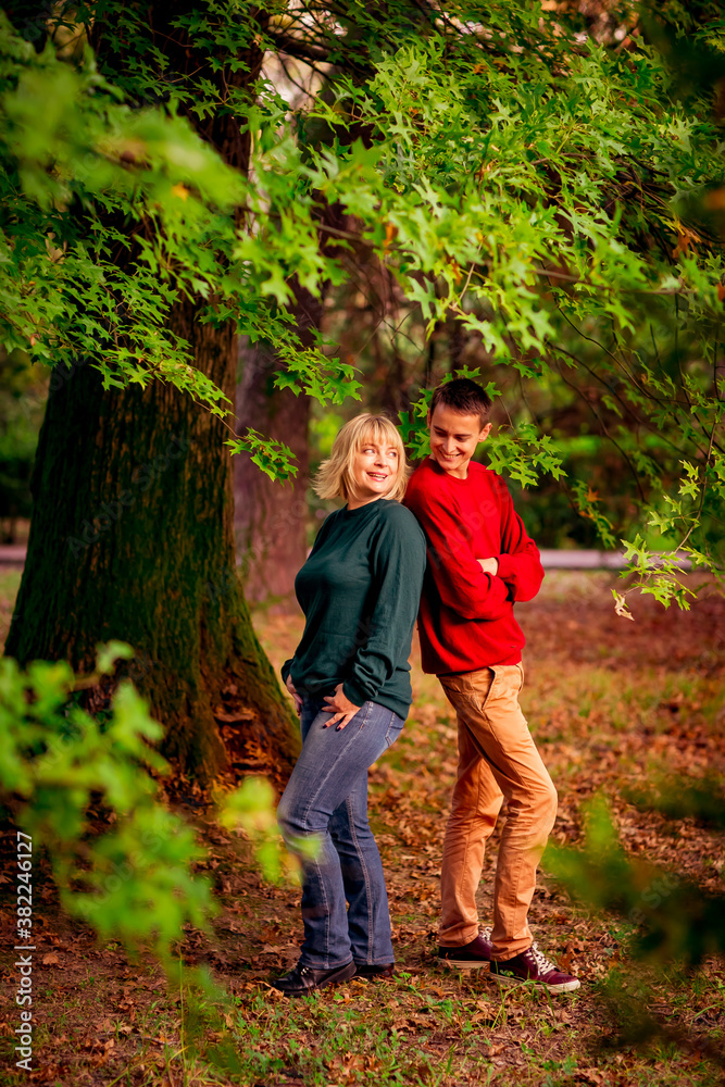 Beautiful woman,blonde,middle-aged,with a big son walking in the Park,a beautiful autumn day Beautiful woman,blonde,middle-aged,with a big son walking in the Park,a beautiful autumn day