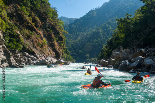 Kayakers negotiate their way through whitewater rapids on the Karnali River in west Nepal photo