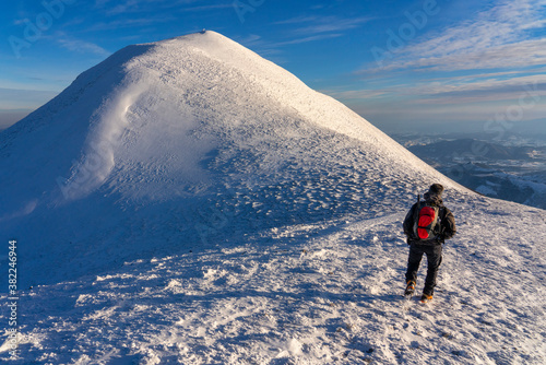 Hiker near the summit in winter, Mount Acuto, Apennines, Umbria